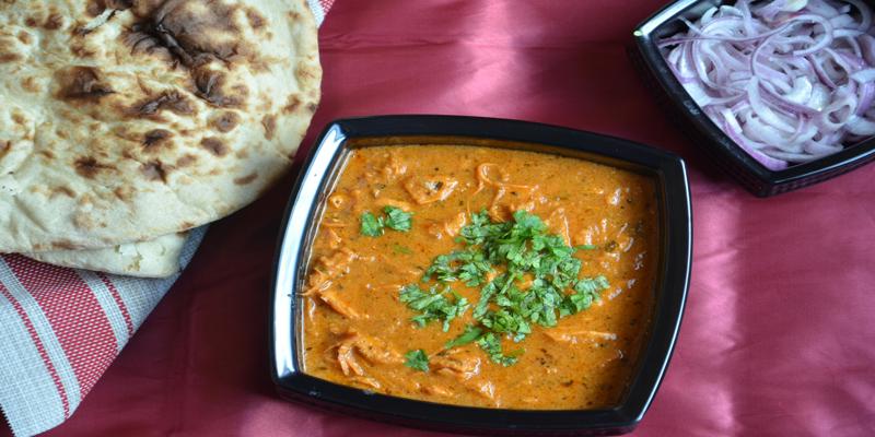 A bowl of food with a fork and spoon

Description automatically generated